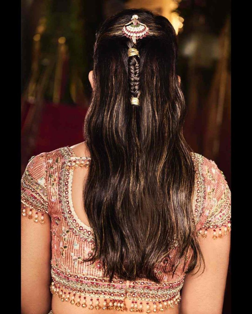 Isha accessorised her hair with a unique jadau hairpin, with diamonds and rubies.